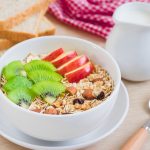Muesli with fresh fruit, milk and whole wheat bread